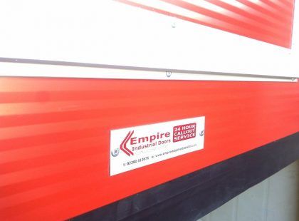 empire industrial door sticker on red door